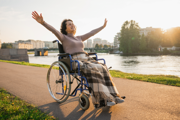 happy senior woman wheelchair raised hands
